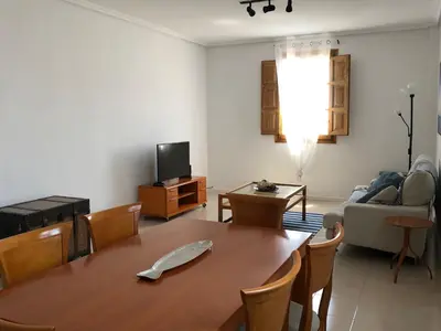 a living room with a table and a couch at Apartamento Puerto de Sagunto Playa in Puerto de Sagunto