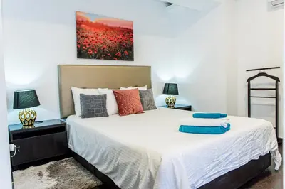 a bedroom with a large bed with two lamps at Catedral Reina Apartaments in Valencia
