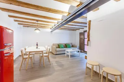 a living room with a table and chairs and a couch at ApartUP Central Market II in Valencia