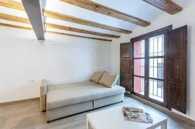 a living room with a couch and a window at ApartUP Central Market II in Valencia