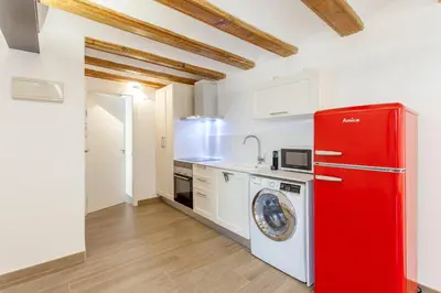 a kitchen with a red refrigerator and a washing machine at ApartUP Central Market II in Valencia