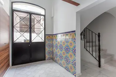 a hallway with a black door and a tile wall at ApartUP Central Market II in Valencia