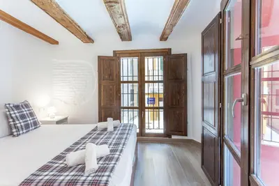 a bedroom with a bed and some windows at ApartUP Central Market II in Valencia