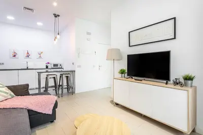 a living room with a flat screen tv on a white wall at G&V APARTMENTS CLOSE to CENTER in Valencia