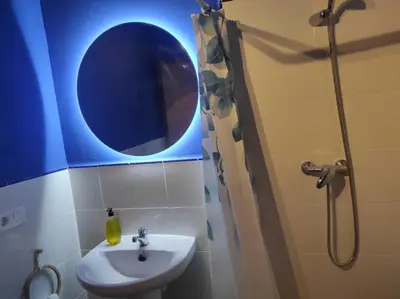 a bathroom with a sink and a mirror and a shower at La Vía Verde in Jérica