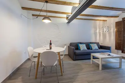 a living room with a table and a couch at ApartUP Central Market I in Valencia
