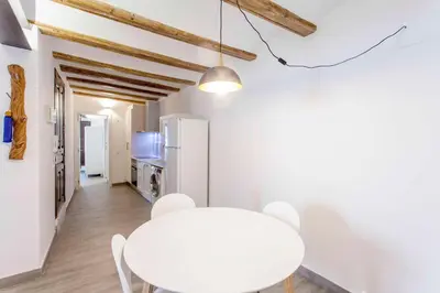 a white dining room with a white table and a white refrigerator at ApartUP Central Market I in Valencia