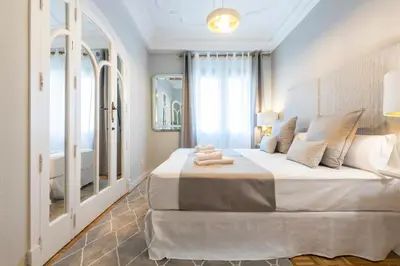 a bedroom with a large bed and a large window at MD Pasaje Ruzafa in Valencia