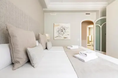 a bedroom with a large white bed with pillows at MD Pasaje Ruzafa in Valencia