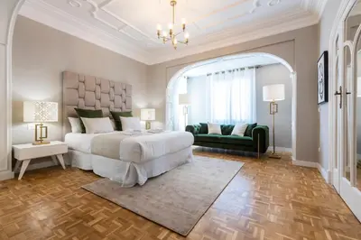 a bedroom with a large bed and a green couch at MD Pasaje Ruzafa in Valencia