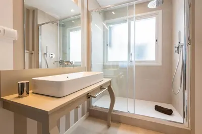 a bathroom with a white sink and a shower at MD Pasaje Ruzafa in Valencia