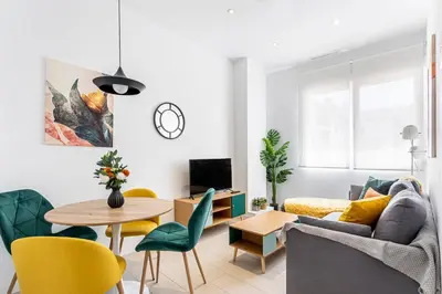 a living room with a couch and a table and chairs at R&C APARTMENTS CLOSE to CENTER in Valencia