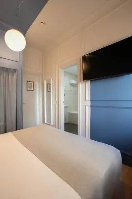 a bedroom with a bed and a flat screen tv at Olympia Consul del Mar in Valencia