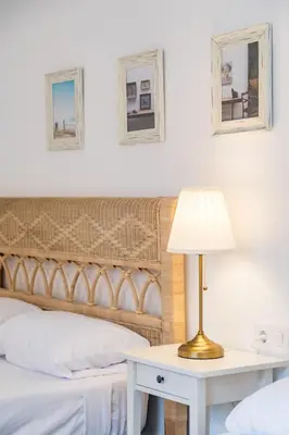 a bedroom with a bed and a table with a lamp at La Colina in Puebla de Vallbona