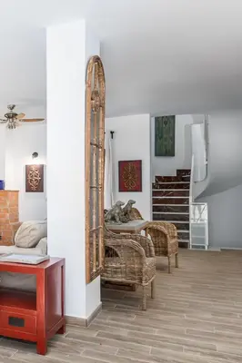 a room with a mirror and a chair and stairs at La Colina in Puebla de Vallbona