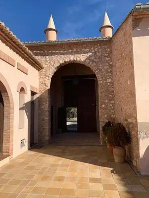 an entrance to a brick building with a door at Castillo con piscina en plena Sierra Calderona in Segorbe