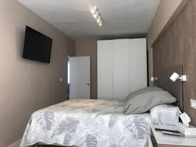 a bedroom with a bed and a television on the wall at Betero Beach & City in Valencia