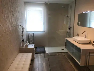 a bathroom with a sink and a shower and a mirror at Betero Beach & City in Valencia