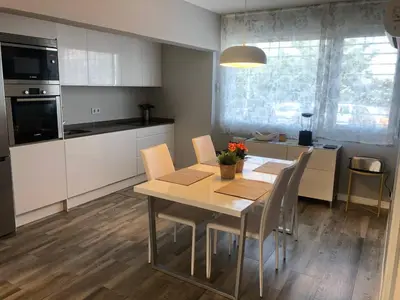 a kitchen with a table and chairs in a kitchen at Betero Beach & City in Valencia