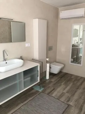 a bathroom with a sink and a toilet and a mirror at Betero Beach & City in Valencia