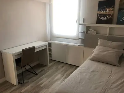 a bedroom with a desk and a bed and a window at Betero Beach & City in Valencia