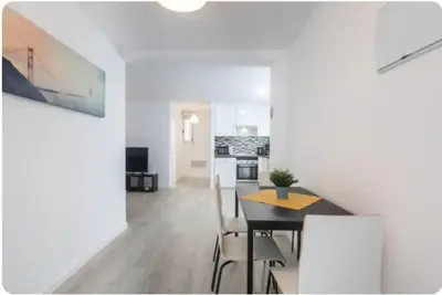 a kitchen and dining room with a table and chairs at Islas Canarias Apartment in Valencia