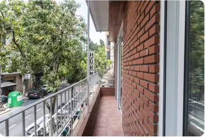 a balcony of a building with a brick wall at Islas Canarias Apartment in Valencia