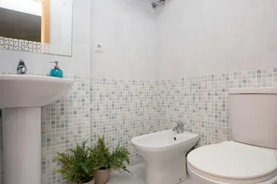 a bathroom with a toilet and a sink at SingularStays Moncofar Beach in Moncófar