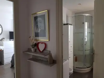 a bathroom with a shower and a heart on the wall at Faro de Cullera I in Faro de Cullera