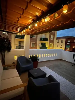 a patio with furniture and a view of a building at Slow Room Valencia in Valencia