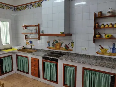 a kitchen with a sink and a stove top oven at Casa Josefina in Yátova