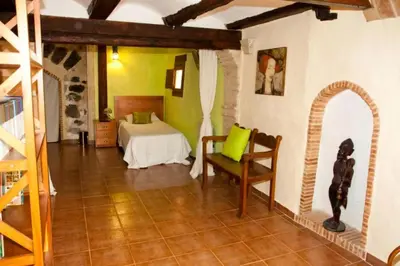 a bedroom with a bed with two lamps on it at La Casa Mora in Jérica