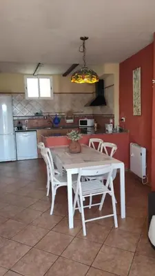a kitchen with a table and chairs in a room at La Media Luna in Segorbe