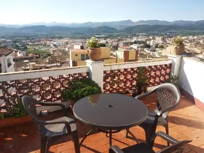 a table and chairs on a balcony with a view at La Media Luna in Segorbe