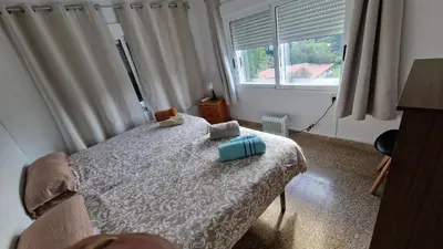 a bedroom with a bed with two pillows on it at Calicanto House & Pool in Torrent