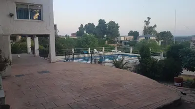 a patio with a swimming pool and a house at Calicanto House & Pool in Torrent