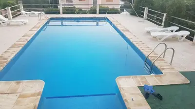 a swimming pool with blue water in a house at Calicanto House & Pool in Torrent