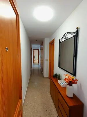 a hallway with a flat screen tv on a wall at Seabreeze Lighthouse Apartment in Faro de Cullera