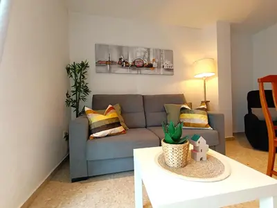 a living room with a couch and a table at Seabreeze Lighthouse Apartment in Faro de Cullera