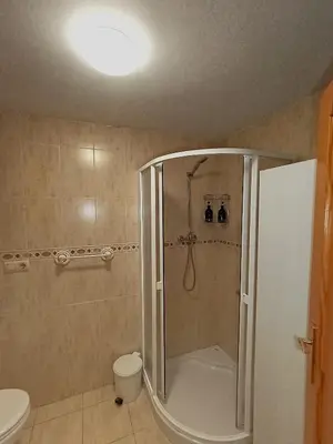 a bathroom with a shower and a toilet at Seabreeze Lighthouse Apartment in Faro de Cullera
