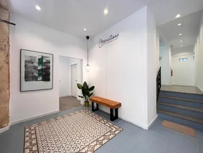 a hallway with a bench and stairs at Maritime Apartamentos Cabañal in Valencia