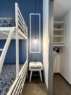 a small room with two bunk beds and a table at Maritime Apartamentos Cabañal in Valencia