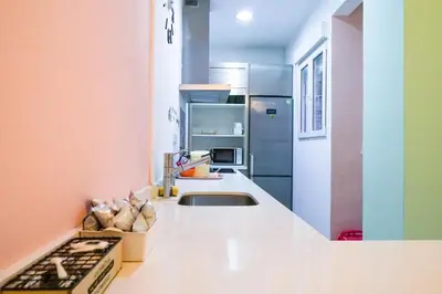a kitchen with a sink and a refrigerator at Ruzafa Apartment in Valencia