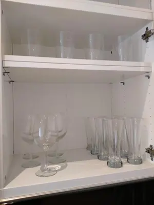 a row of wine glasses sitting on a shelf at Cabañal Port Marina in Valencia