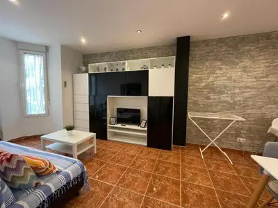 a living room with a couch and a fireplace at Cabañal Port Marina in Valencia