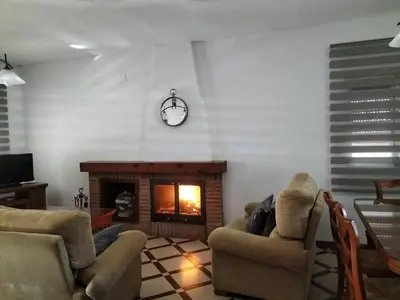 a living room with two chairs and a fireplace at Ca Michico in Tous