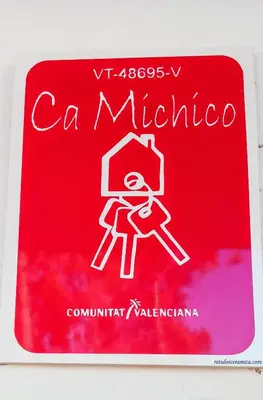 a red book with a picture of a person on it at Ca Michico in Tous