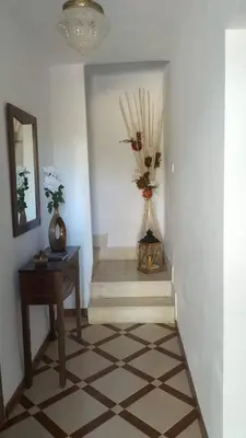 a hallway with a staircase with a table and a mirror at Ca Michico in Tous