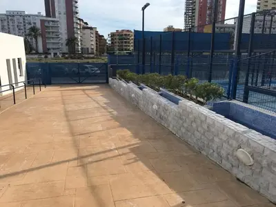 a patio with a retaining wall and a fence at Playa Valencia Residencial Sol y Mar Terraza con Vistas y Parking in Playa Pobla de Farnals