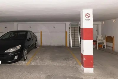 a parking garage with a car parked in it at ROS MARY, 7º-14 in Cullera